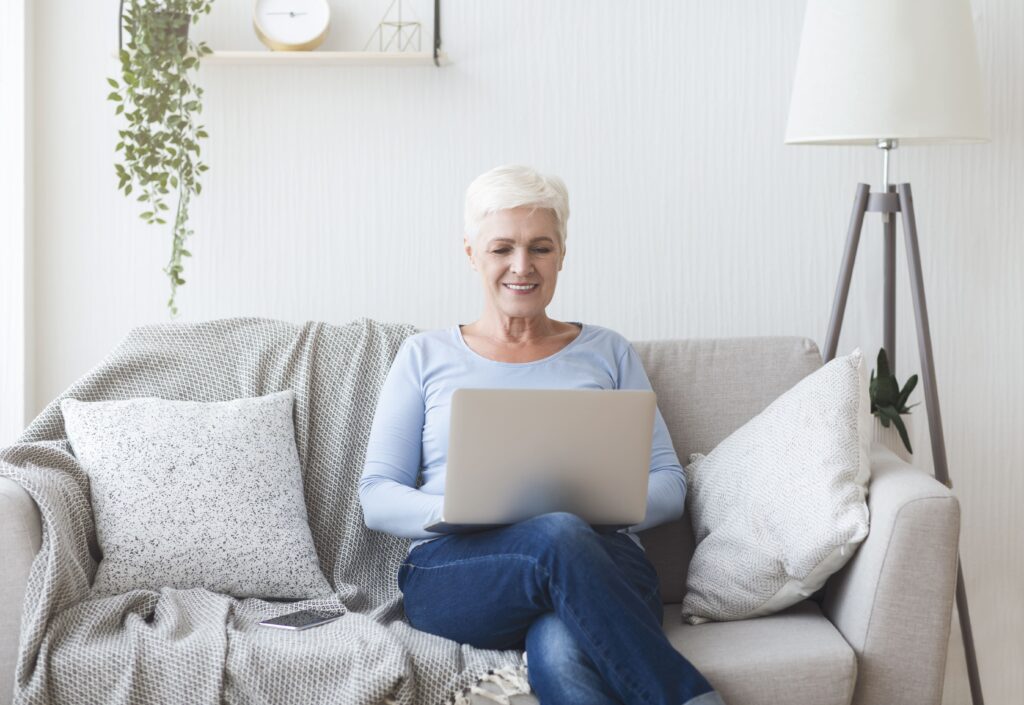 ambitious-senior-lady-using-laptop-on-sofa-at-home-2025-03-18-17-56-55-utc (1) (1)